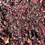 Organic dried hibiscus petals for herbal tea, rich red color, sun-dried.