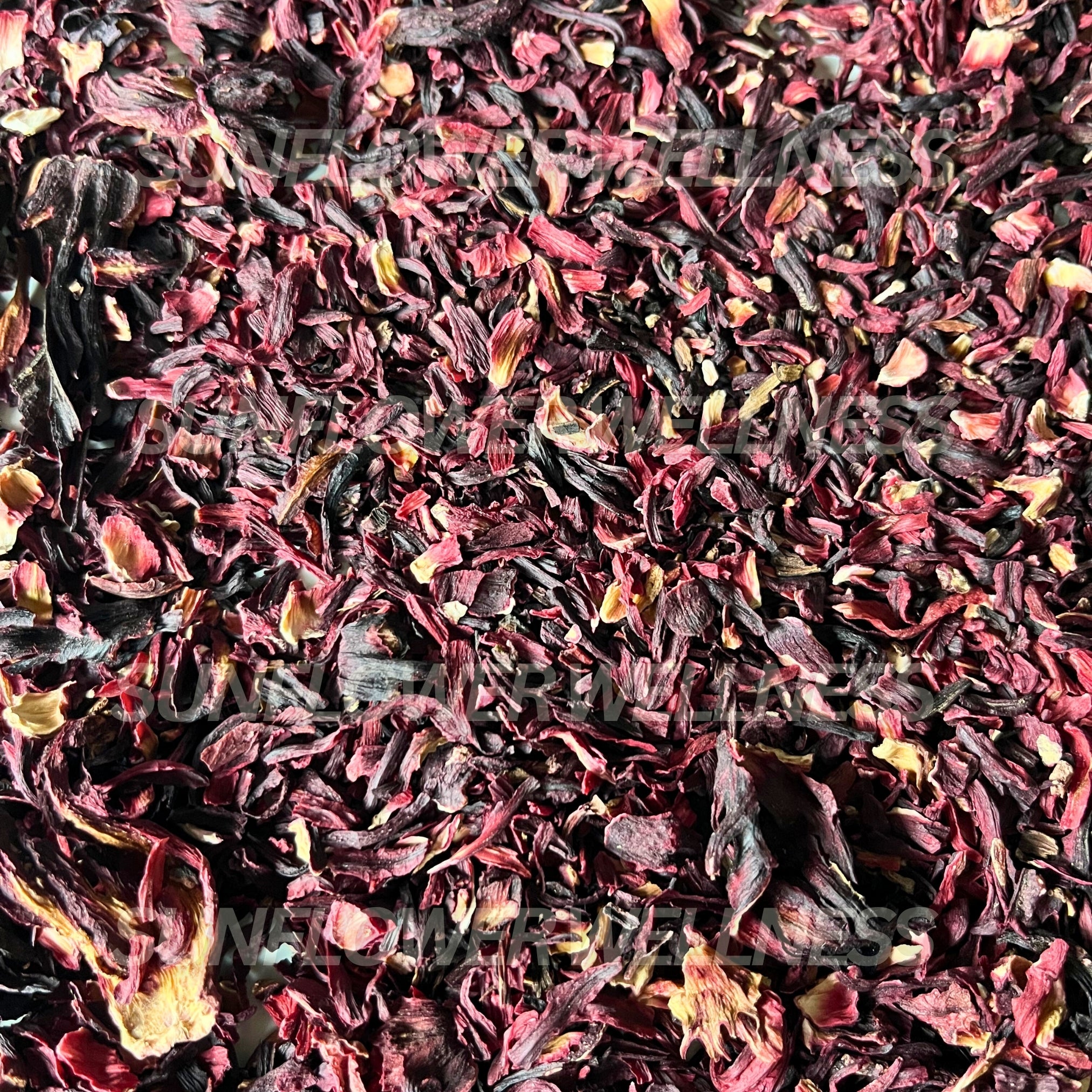 Organic dried hibiscus petals for herbal tea, rich red color, sun-dried.