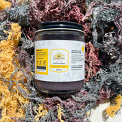 Sunflower Wellness Full Spectrum Sea Moss Gel jar nestled in dried gold, green, and purple sea moss strands harvested from the Caribbean.